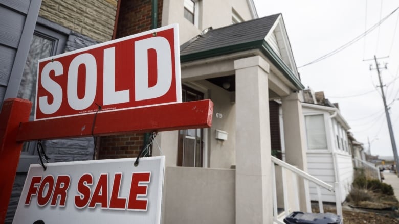 A "Sold" sign in front of a home in the York neighborhood of Toronto, Ontario