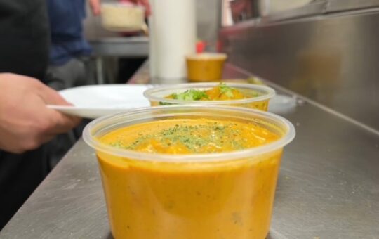 A curry dish in a plastic container.