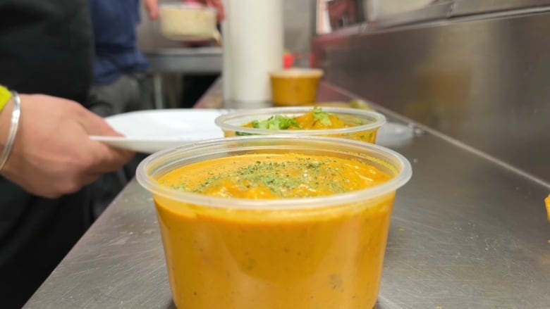 A curry dish in a plastic container. 