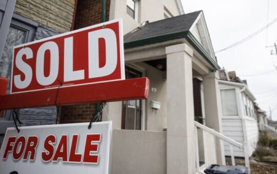 A "Sold" sign in front of a home in the York neighborhood of Toronto, Ontario